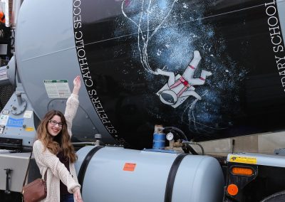 Student in front of a Sarjeant Company concrete truck with artwork from the Sarjeant Co. Design Project